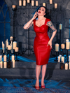 With the BRAM STOKER'S DRACULA Quilted Order of the Dragon Armor Skater Skirt in Blood Red Vegan Leather, Micheline Pitt brings a touch of gothic flair to the candle-lit dungeon, showcasing the craftsmanship of La Femme en Noir's goth fashion.