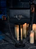 Surrounded by the enchanting glow of flickering candles, the BRAM STOKER'S DRACULA Gargoyle Sculpture Quilted Crossbody Bag in Black finds its place, a creation by the gothic fashion house, La Femme en Noir.