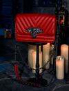 In the midst of flickering candles, the BRAM STOKER'S DRACULA Gargoyle Sculpture Quilted Crossbody Bag in Blood Red takes its place, a creation by the gothic fashion house, La Femme en Noir.