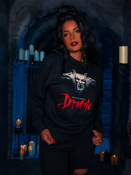 Amidst the shadows of a poorly lit dungeon, the earthly mannequin exhibits the Gargoyle Sculpture Sweatshirt in Black, a masterpiece from La Femme en Noir's BRAM STOKER'S DRACULA collection.