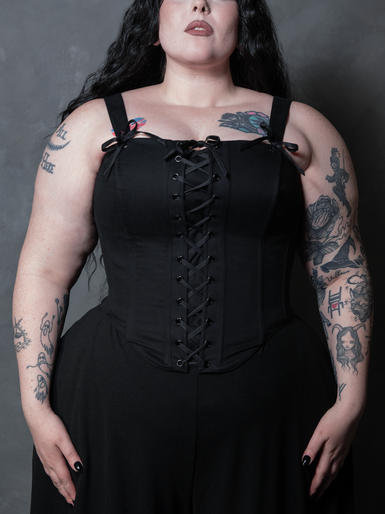 A striking female model showcases the ultimate piece of gothic clothing, radiating an aura of romantic mystery and classic dark glamour.