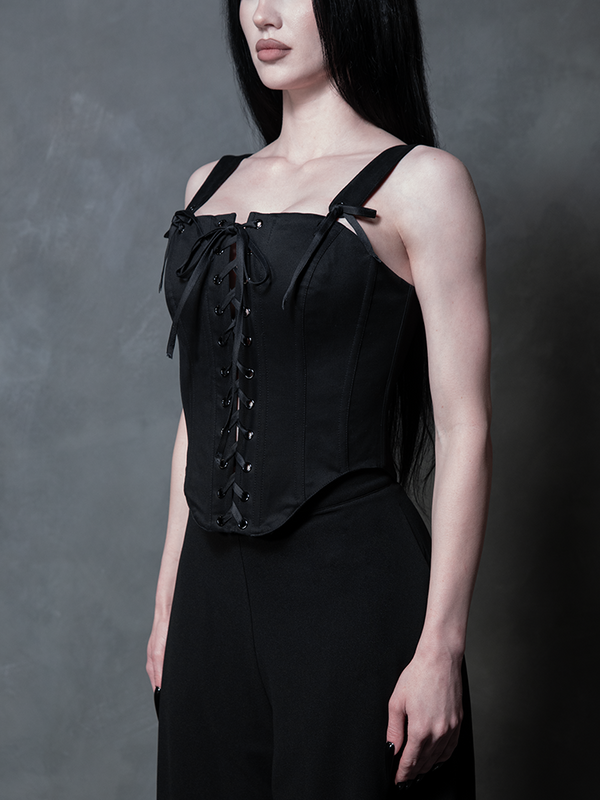 A female model wears a luxurious black sateen corset, epitomizing the enchanting allure of modern Whimsigoth style.