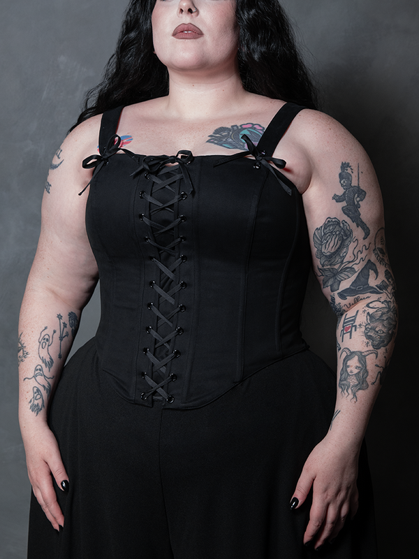 A female model brings an air of aristocratic dark elegance to life, adorned in a dramatic black cotton corset.