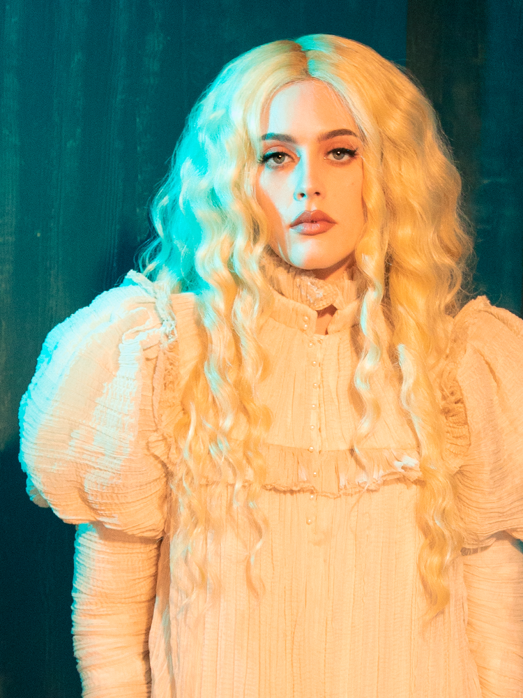 The CRIMSON PEAK™ Edith Victorian Gown carries the ghosts of romance in its seams. Its ivory silk and lace are the materialization of unspoken desires and whispered promises. Wearing this gown, one cannot help but feel transported to an age of grand balls and Gothic intrigue, where every glance holds a secret.