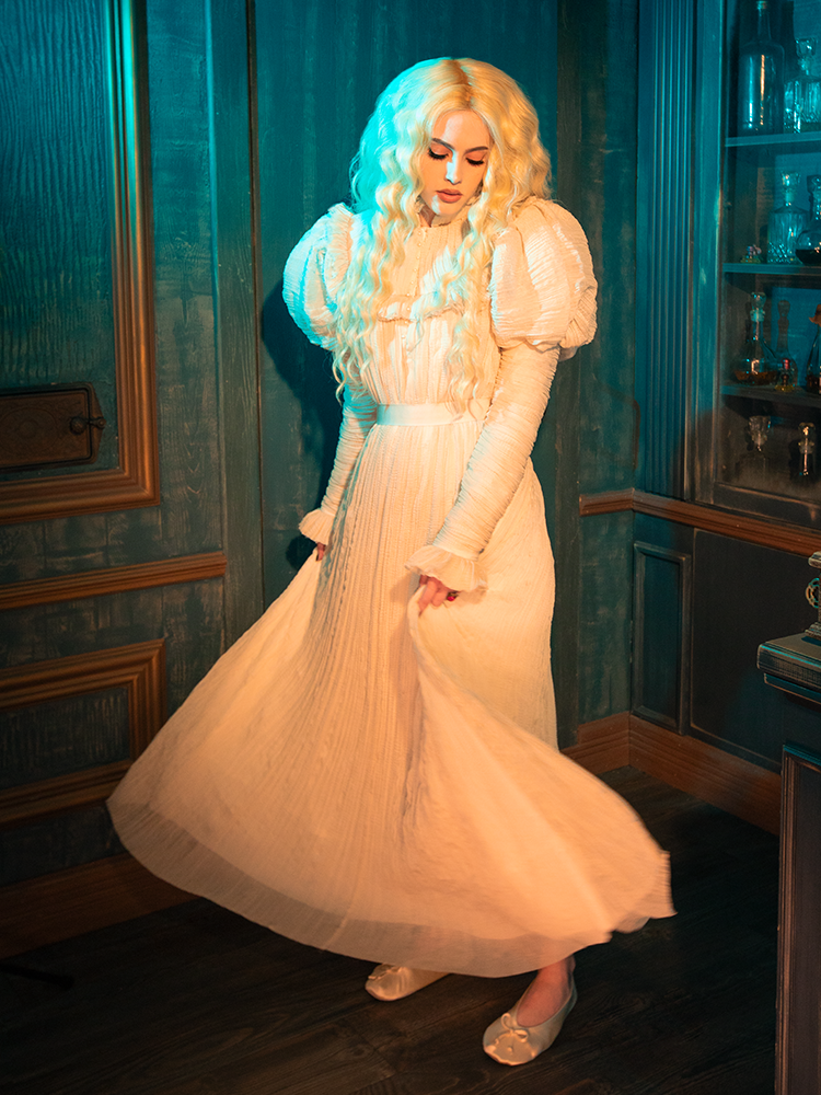 Draped in the Edith Victorian Gown, you are the embodiment of a Victorian dream. The gown's rich ivory fabric and delicate lace details transport you to a world where love letters are penned by candlelight, and beauty is found in the subtlest of gestures. This gown is not merely a dress; it is an ode to the poetry of the past.
