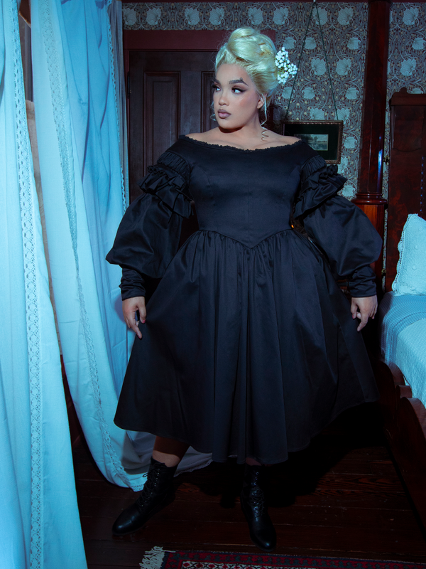 A female model showcases the breathtaking artistry of alternative fashion, wearing the timeless Ellen Victorian Dress in Black.
