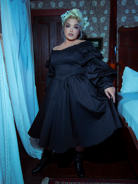 Step into gothic grandeur with the Ellen Victorian Dress in Black. Its velvet-trimmed lace bodice and flowing silk skirt are tailored for dramatic entrances and whispered secrets.