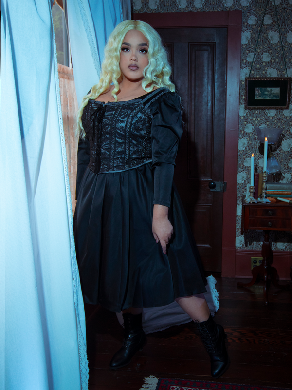 Infused with antique charm and Victorian Goth sensibilities, a female model wears the dramatic Gothic Glamour Bustier in Black.
