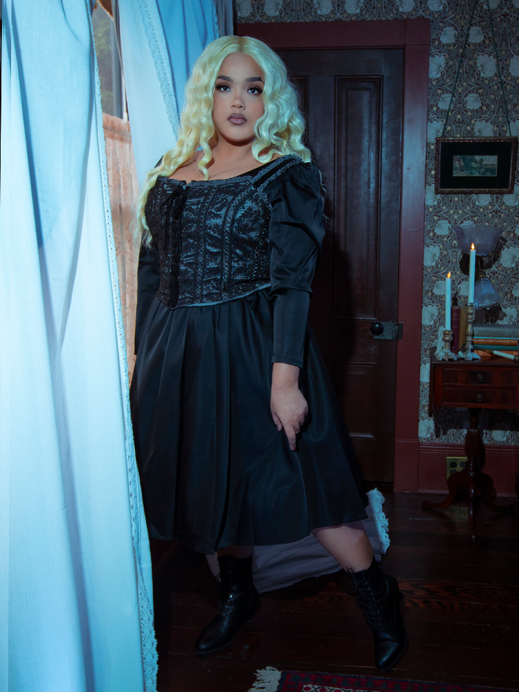 Infused with antique charm and Victorian Goth sensibilities, a female model wears the dramatic Gothic Glamour Bustier in Black.