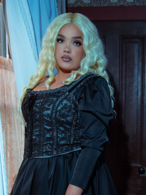 The essence of a gothic femme fatale is brought to life as a female model styles the captivating Gothic Glamour Bustier in Black.