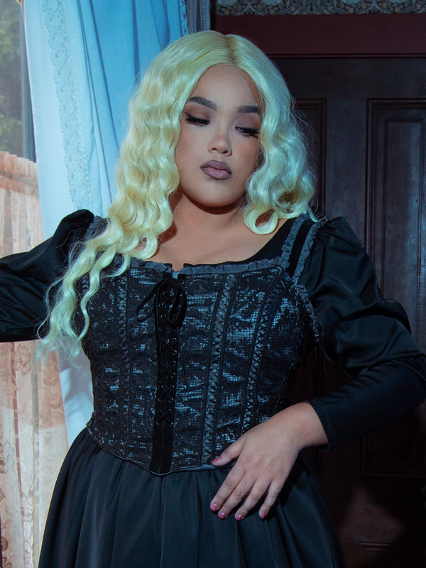 A female model embodies the pinnacle of gothic glamour, her presence steeped in dark elegance while wearing the striking Gothic Glamour Bustier in Black.