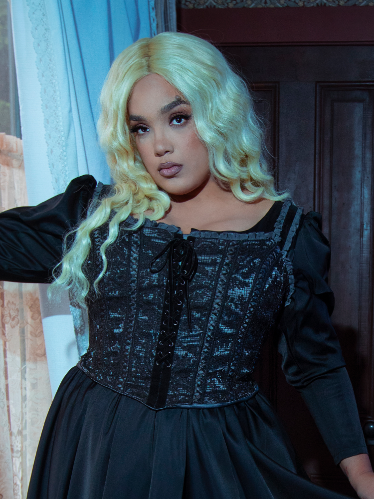 A female model showcases the seductive, moody charm of alternative luxury fashion in the timeless Gothic Glamour Bustier in Black.