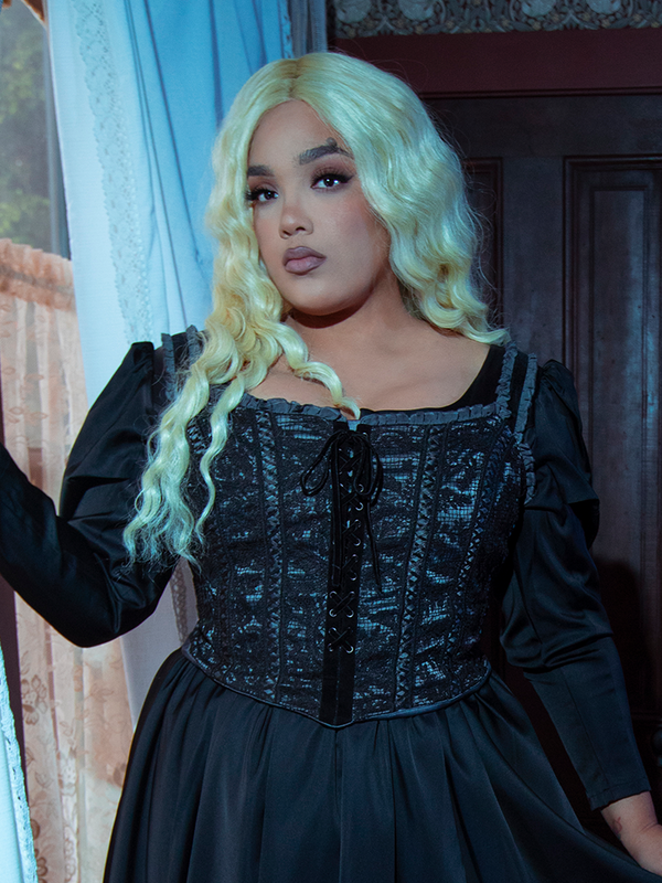 Cloaked in the rich midnight tones of the Gothic Glamour Bustier in Black, a female model steps out as a vision of romantic noir sophistication.