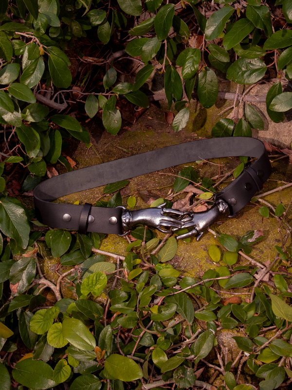 Prepare to be entranced by the haunting beauty of the model adorned in the Victorian Hands Belt in Gunmetal, an enigmatic treasure brought to life by the gothic craftsmanship of La Femme en Noir Clothing.