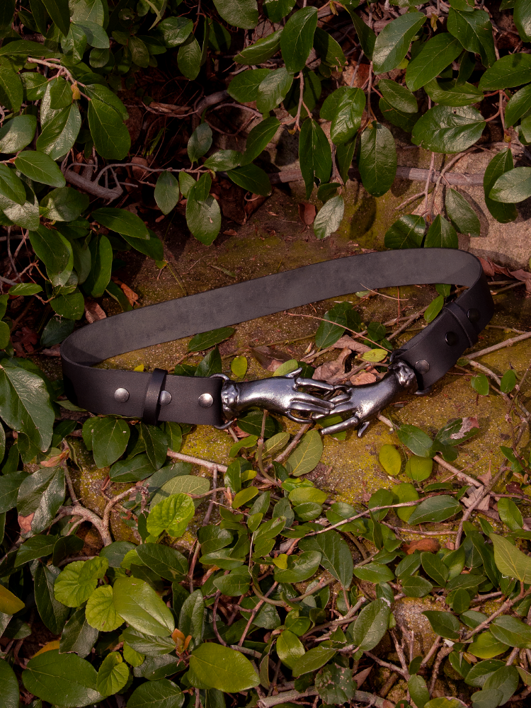 Prepare to be entranced by the haunting beauty of the model adorned in the Victorian Hands Belt in Gunmetal, an enigmatic treasure brought to life by the gothic craftsmanship of La Femme en Noir Clothing.