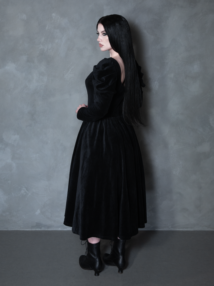 Female model wearing the Haunted Beauty Victorian Mourning Dress & Capelet Set in Black, capturing alternative fashion elegance and sinister beauty.