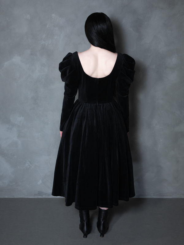 Model styled in the Haunted Beauty Victorian Mourning Dress & Capelet Set in Black, manifesting dark couture design and haunting allure.