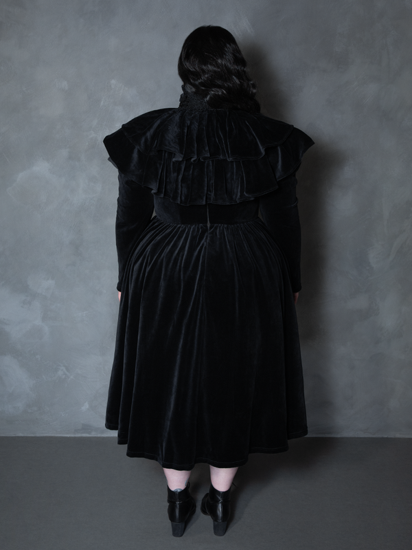 Female model wearing the Haunted Beauty Victorian Mourning Dress & Capelet Set in Black, capturing atmospheric dark beauty and bewitching presence.