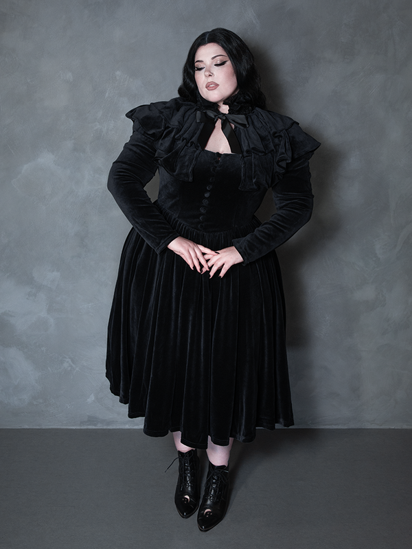Female model wearing the Haunted Beauty Victorian Mourning Dress & Capelet Set in Black, showcasing noir elegance and romantic goth attire.