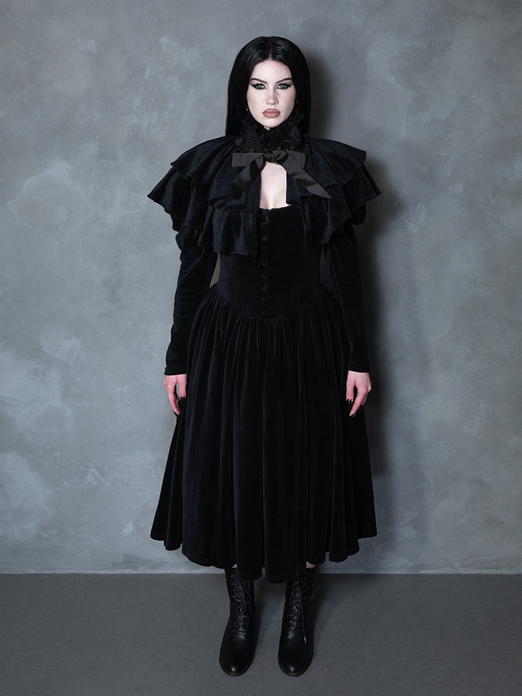 Model styled in the Haunted Beauty Victorian Mourning Dress & Capelet Set in Black, reflecting dark academia clothing trends and bewitching sophistication.