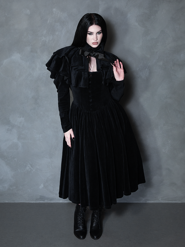 Female model wearing the Haunted Beauty Victorian Mourning Dress & Capelet Set in Black, showcasing high-fashion gothic glamour and shadowy grace.
