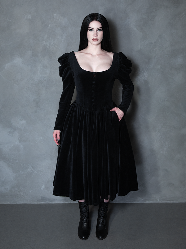 Female model wearing the Haunted Beauty Victorian Mourning Dress & Capelet Set in Black, evoking dark romantic apparel and ethereal moodiness.