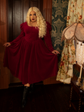 The Haunted Beauty Victorian Dress in Crimson exudes dark fairytale charm, with its elegantly ruffled high collar, intricate lace sleeves, and a sweeping skirt that captures the essence of gothic romance.