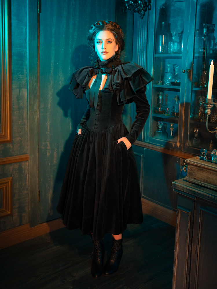 In the twilight's embrace, the Haunted Beauty dress shines. The capelet, a shadow in the fading light, offers a connection to the ethereal, a garment that dances on the edge of day and night, life and something beautifully beyond.