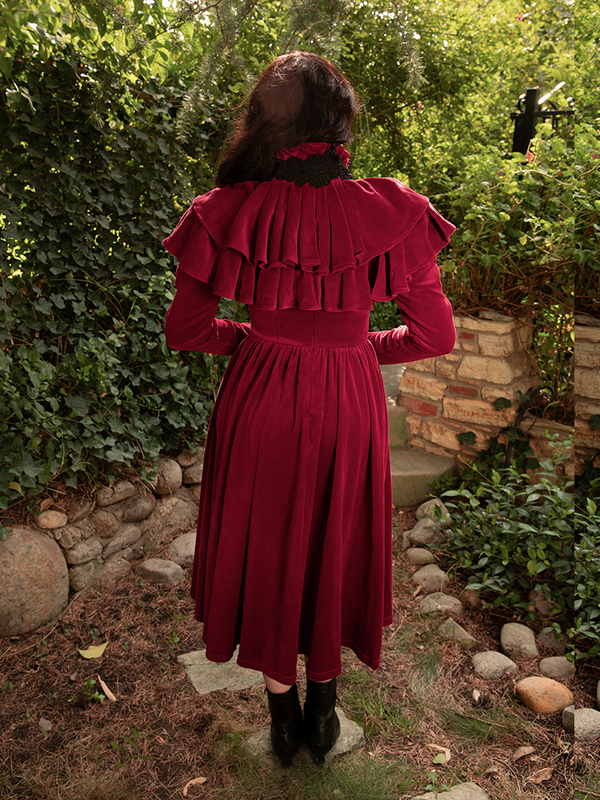 Every movement of Micheline Pitt in the Haunted Beauty Capelet tells a story of dark romance—crimson folds that whisper secrets of desire and dominion.