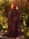 The Heroine Maxi Dress in Pomegranate Print is a darkly romantic creation, perfect for those who embrace gothic elegance. Its rich crimson pattern and flowing fabric whisper tales of forbidden love.