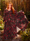 The Heroine Maxi Dress in Pomegranate Print is a dark, romantic masterpiece. Its deep crimson hues and elegant silhouette evoke the spirit of gothic poetry and forbidden love.