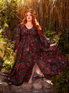 The Heroine Maxi Dress in Pomegranate Print is a gothic vision of beauty, perfect for evening galas and midnight escapades. Its rich crimson pattern and flowing silhouette create an air of captivating mystery.