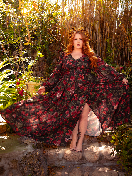 Adorn yourself in the Heroine Maxi Dress in Pomegranate Print, a masterpiece of gothic glamour. With its deep red hues and ethereal design, it whispers of dark romance and timeless elegance.