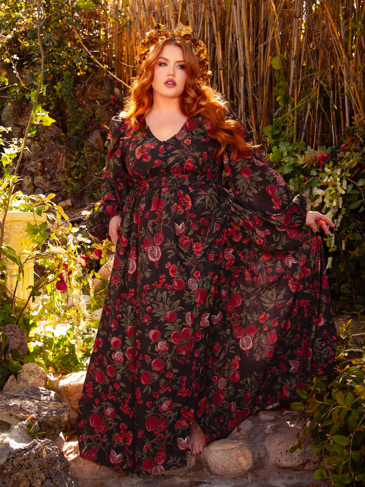 Step into a world of dark elegance with the Heroine Maxi Dress in Pomegranate Print. The rich, crimson pattern and flowing fabric make it perfect for nights of passion and whispers in the dark.