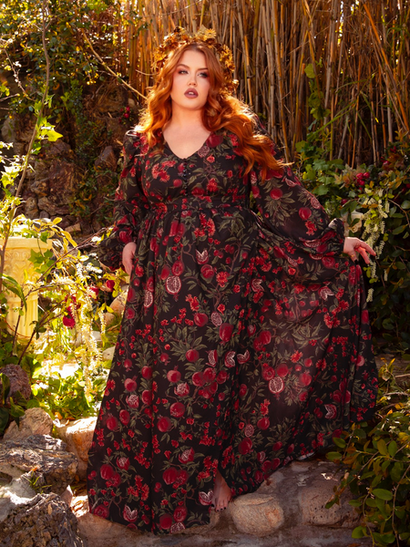 Step into a world of dark elegance with the Heroine Maxi Dress in Pomegranate Print. The rich, crimson pattern and flowing fabric make it perfect for nights of passion and whispers in the dark.