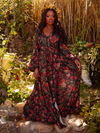 Indulge in the dark romance of the Heroine Maxi Dress in Pomegranate Print. With its deep red hues and elegant design, it creates an enchanting aura, perfect for moonlit gardens and whispered secrets.