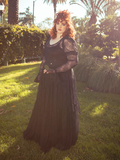 The Juliet Sheer Lace Maxi Dress in Black dances with the essence of romance, its delicate lace and flowing form echoing eternal elegance.