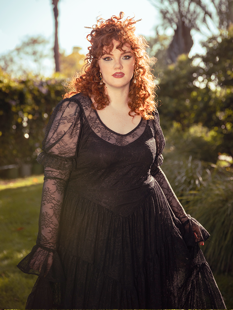 A vision of midnight romance, the Juliet Sheer Lace Maxi Dress in Black drapes the body in ethereal lace, a hauntingly elegant silhouette for moonlit soirees.