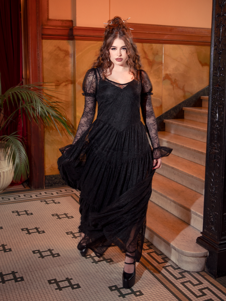 Flowing like twilight shadows, the Juliet Sheer Lace Maxi Dress in Black transforms every step into a dance of gothic beauty and ethereal grace.