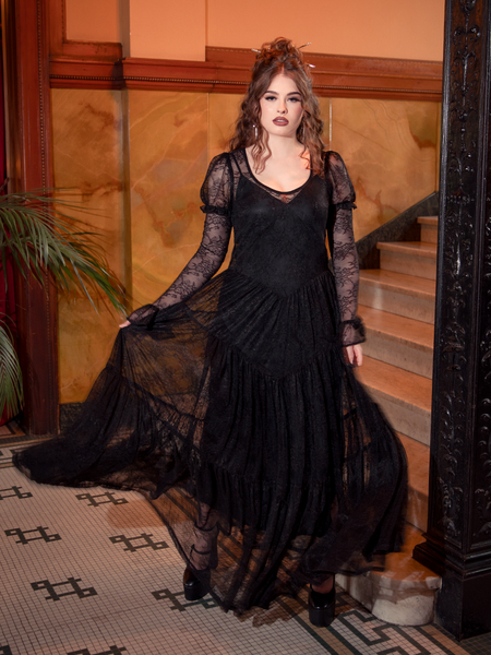 The Juliet Sheer Lace Maxi Dress in Black whispers of gothic fairy tales, a gown of lace and elegance crafted for dreamers of the night.