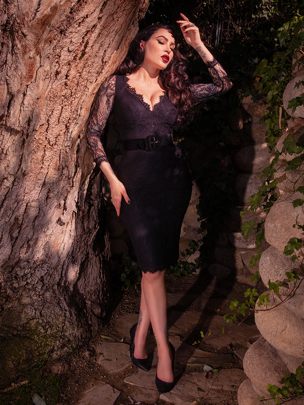 Wrapped in the seductive luxury of a black lace dress, a female model channels timeless gothic couture and effortless edge, an essential piece for the modern woman's dark alternative wardrobe.