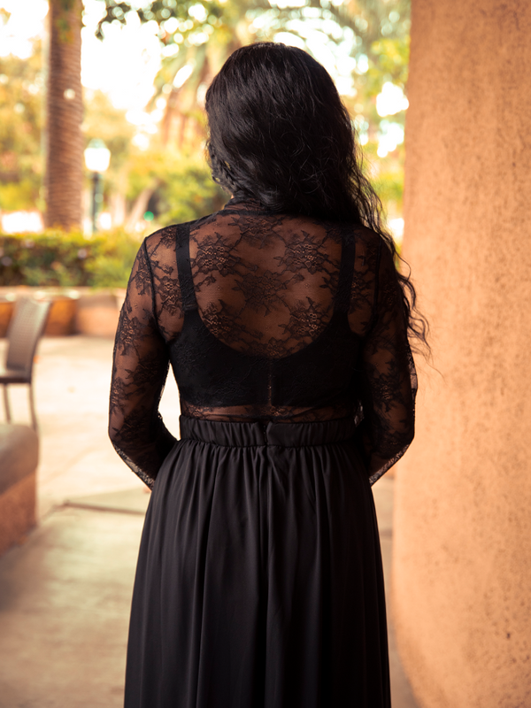 For moonlit outings or candlelit dinners, the Lace Base Top in Black radiates timeless gothic charm, offering sultry elegance with sheer lace accents.