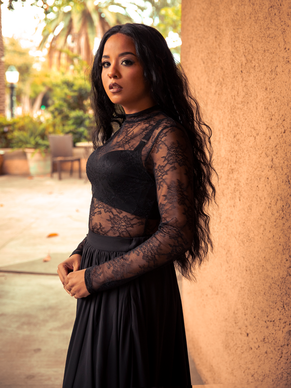 Whispering of midnight secrets, the Lace Base Top in Black layers delicate lace over soft fabric, perfect for both daring evenings and casual dark romance. Available XS–4X.