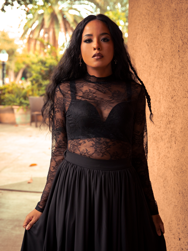 Mystical yet versatile, the Lace Base Top in Black enchants with lace sleeves and a fitted silhouette, pairing flawlessly with skirts or trousers for gothic sophistication.