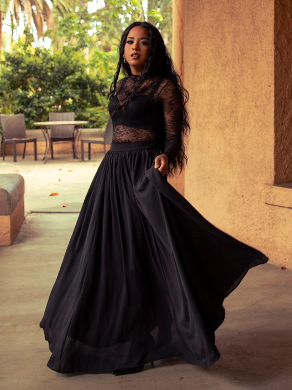 A second-skin of shadow, the Lace Base Top in Black hugs curves with elegance, its sheer detailing offering allure that transitions effortlessly from day to night.