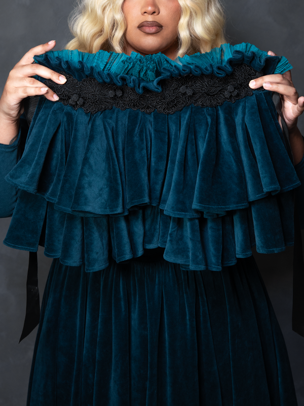 Female model wearing the CRIMSON PEAK™ Lady Lucille Victorian Dress with Capelet in Teal, capturing alternative fashion elegance and macabre beauty.