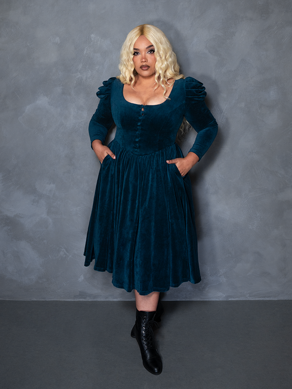 Model styled in the CRIMSON PEAK™ Lady Lucille Victorian Dress with Capelet in Teal, reflecting victorian gothic clothing and bewitching sophistication.