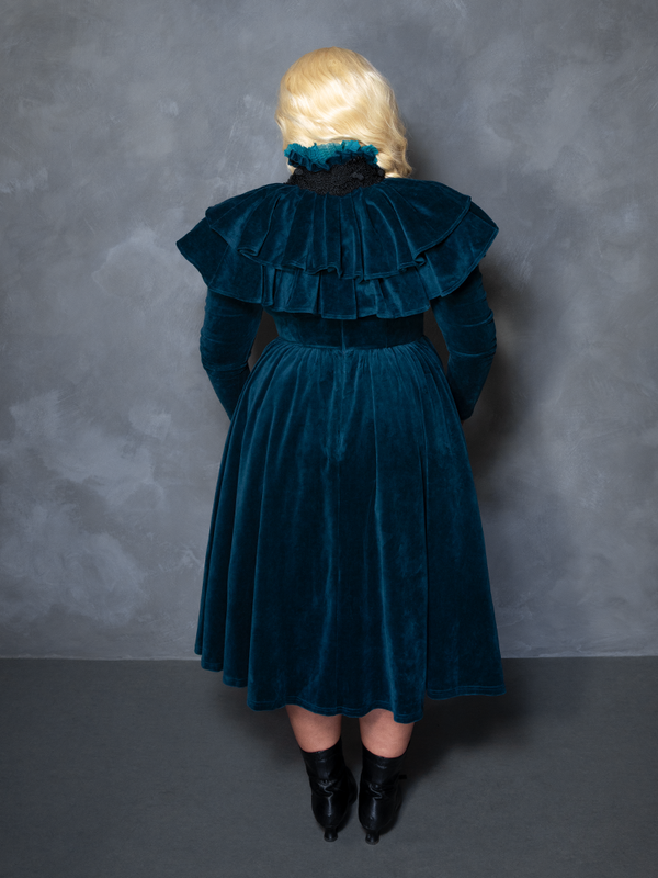 Model styled in the teal CRIMSON PEAK™ Lady Lucille Victorian Dress with Capelet, exuding gothic royalty and enchanted noir style.