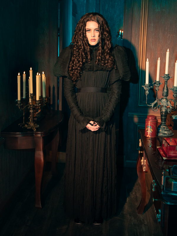  Dance with the shadows in the Lady Mourning Victorian Gown. Its silhouette swirls around you, a partner in the dance of the night. The velvet and lace are the music of this waltz, a melody of dark elegance that resonates with the soul. This gown isn't just a piece of clothing; it's a journey into the heart of gothic romance.