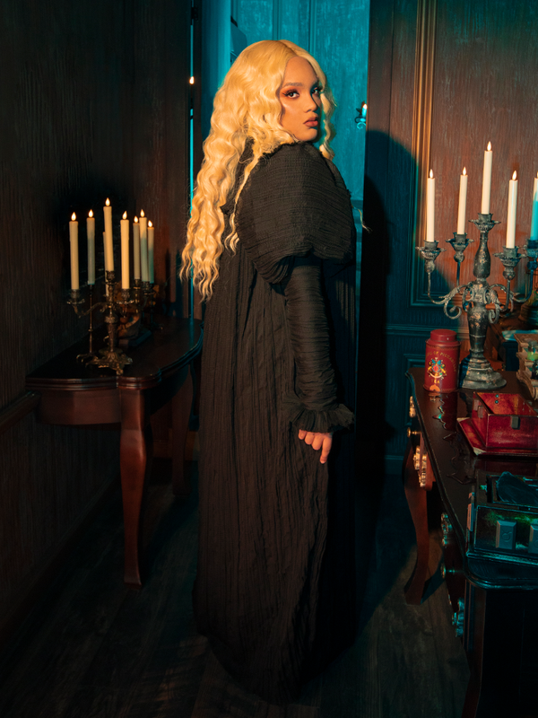 Embrace the somber grace of Victorian mourning attire with this exquisitely crafted gown. The luxurious velvet hugs your form, creating a silhouette that speaks of sorrowful elegance.